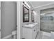 Bathroom featuring a dual sink vanity, soaking tub and a glass-enclosed shower with tile accents at 1819 Sw 29Th St, Ocala, FL 34471
