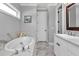 Well-lit bathroom features soaking tub, vanity, stylish fixtures, and tile flooring at 1819 Sw 29Th St, Ocala, FL 34471