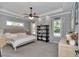 Spacious bedroom with tray ceiling and windows at 1819 Sw 29Th St, Ocala, FL 34471