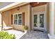 Charming entryway with decorative glass double doors, a tiled porch, and a cozy bench for a welcoming first impression at 1819 Sw 29Th St, Ocala, FL 34471