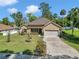 Inviting single-story home featuring lush landscaping, a well-manicured lawn, and a two-car garage, showcasing great curb appeal at 1819 Sw 29Th St, Ocala, FL 34471