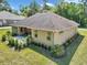 Exterior view of the home highlighting its well-maintained landscaping, neutral color scheme, and outdoor patio area at 1819 Sw 29Th St, Ocala, FL 34471