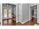 Hallway with hardwood floors leads past storage and into the house; a glimpse of the entry doors can be seen at 1819 Sw 29Th St, Ocala, FL 34471