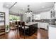 Elegant kitchen featuring a central island with bar seating, stainless steel appliances, and wood flooring at 1819 Sw 29Th St, Ocala, FL 34471