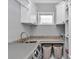 Well-organized laundry area with ample storage, modern appliances, and a convenient sink at 1819 Sw 29Th St, Ocala, FL 34471