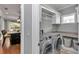 Functional laundry room with modern machines, storage, and easy access from the kitchen at 1819 Sw 29Th St, Ocala, FL 34471