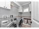 Clean laundry room with modern washer and dryer, storage cabinets, and a sink at 1819 Sw 29Th St, Ocala, FL 34471