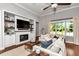 Cozy living room with built-in shelves, fireplace, and a comfortable seating area at 1819 Sw 29Th St, Ocala, FL 34471