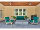 Inviting outdoor patio with comfortable seating, a modern gas fire pit, and a stained wood plank ceiling with fans at 1819 Sw 29Th St, Ocala, FL 34471
