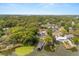 Picturesque aerial view of a charming lakeside community with private boat docks surrounded by mature trees at 201 Cedarwood Dr, Maitland, FL 32751