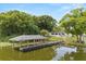 Aerial view of a waterfront home with a large covered boat dock and lush green surroundings at 201 Cedarwood Dr, Maitland, FL 32751