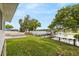 Beautiful backyard featuring a well-maintained lawn and a covered boat dock on the tranquil lake at 201 Cedarwood Dr, Maitland, FL 32751
