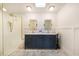 Stylish bathroom with a shower, double vanity, tile floors, and modern wall paneling at 201 Cedarwood Dr, Maitland, FL 32751