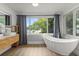 Relaxing bathroom with a soaking tub, waterfront view, and a modern single sink vanity at 201 Cedarwood Dr, Maitland, FL 32751