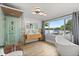 Elegant bathroom with a soaking tub, walk-in shower, double vanity, and waterfront view at 201 Cedarwood Dr, Maitland, FL 32751