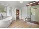 Stylish bathroom featuring a soaking tub, a modern shower, and access to the Primary bedroom at 201 Cedarwood Dr, Maitland, FL 32751