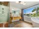 Serene bathroom featuring a modern shower, double vanity, and waterfront views at 201 Cedarwood Dr, Maitland, FL 32751