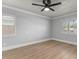 Bright bedroom with neutral walls, wood flooring, and natural light from shuttered windows at 201 Cedarwood Dr, Maitland, FL 32751