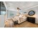 Luxurious bedroom with tufted headboard, hardwood floors, and a stylish dresser with round mirrors at 201 Cedarwood Dr, Maitland, FL 32751