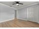 Spacious bedroom with a ceiling fan, hardwood floors, and ample closet space at 201 Cedarwood Dr, Maitland, FL 32751