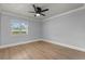 Empty bedroom featuring a ceiling fan, neutral colors, and a window for natural light at 201 Cedarwood Dr, Maitland, FL 32751