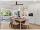 Dining area with modern lighting fixtures, a wine cooler, coffee machine and views of the greenery outside at 201 Cedarwood Dr, Maitland, FL 32751