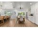 Dining area with modern lighting fixtures, a wine cooler, coffee machine and views of the greenery outside at 201 Cedarwood Dr, Maitland, FL 32751