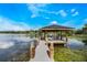 Inviting dock with shaded sitting area, perfect for enjoying tranquil lake views and waterfront relaxation at 201 Cedarwood Dr, Maitland, FL 32751