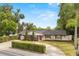Lovely single-story home featuring a well-manicured lawn, trimmed hedges, and an attached two-car garage at 201 Cedarwood Dr, Maitland, FL 32751