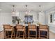Modern kitchen featuring a large island, pendant lighting, stainless steel appliances, and stylish bar stools at 201 Cedarwood Dr, Maitland, FL 32751
