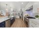 Open-concept kitchen with a large island, stainless steel appliances, and seamless flow into the living area at 201 Cedarwood Dr, Maitland, FL 32751