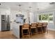 Bright kitchen showcasing a waterfall island, stainless steel appliances, and a large window for natural light at 201 Cedarwood Dr, Maitland, FL 32751