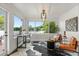 Bright sunroom featuring lake views, modern furnishings, and elegant decor at 201 Cedarwood Dr, Maitland, FL 32751