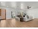 Bright and airy living room with wood floors, modern decor, and large windows offering plenty of natural light at 201 Cedarwood Dr, Maitland, FL 32751