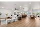 Spacious open-concept living area featuring wood floors, modern furnishings, and seamless flow to the kitchen at 201 Cedarwood Dr, Maitland, FL 32751