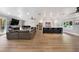 Open-concept living space featuring a modern kitchen, expansive seating, and an abundance of natural light at 201 Cedarwood Dr, Maitland, FL 32751