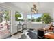 Bright sunroom featuring waterfront views, black and white patterned flooring, and stylish decor at 201 Cedarwood Dr, Maitland, FL 32751