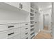 Spacious walk-in closet with custom built-in shelving, drawers, and ample storage space at 201 Cedarwood Dr, Maitland, FL 32751