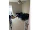 Bedroom with a ceiling fan, window, and bed covered in black bedding, offering potential for personalization at 2053 #E Dixie Belle Dr # E, Orlando, FL 32812