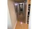 Hallway with hardwood floors connecting to the kitchen, offering a seamless flow between living spaces at 2053 #E Dixie Belle Dr # E, Orlando, FL 32812