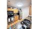 Efficient kitchen design with stainless steel appliances, wood cabinets and granite countertops at 2053 #E Dixie Belle Dr # E, Orlando, FL 32812