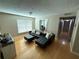 Comfortable living area with a plush leather sofa, light hardwood floors, and bright natural light at 2053 #E Dixie Belle Dr # E, Orlando, FL 32812