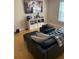 Cozy living room with a modern leather sofa and a large flatscreen TV mounted on the wall at 2053 #E Dixie Belle Dr # E, Orlando, FL 32812