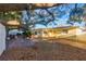 Expansive backyard with brick patio, mature shade trees, and an outdoor seating area perfect for gatherings at 2070 Keyes Ln, Deltona, FL 32738