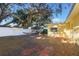 Spacious backyard featuring a hammock, brick patio, lush greenery and mature trees at 2070 Keyes Ln, Deltona, FL 32738