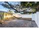 Relaxing backyard with a brick-paved patio and a swaying hammock suspended from a large, shady tree at 2070 Keyes Ln, Deltona, FL 32738