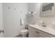 Bright bathroom featuring a toilet, vanity with sink, and a wall mirror at 2070 Keyes Ln, Deltona, FL 32738