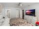 Bright bedroom with a ceiling fan, closet, and a large television on a white dresser at 2070 Keyes Ln, Deltona, FL 32738