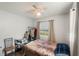 Modest bedroom featuring neutral colors, a window with natural light, and hardwood style flooring at 2070 Keyes Ln, Deltona, FL 32738