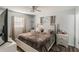 A well-lit bedroom features a bed with white frame, hardwood floors and neutral window coverings at 2070 Keyes Ln, Deltona, FL 32738